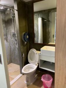 a bathroom with a shower and a toilet and a sink at 09 Hostel Chiangmai in Chiang Mai
