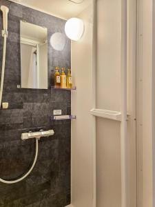 a bathroom with a sink and a mirror at Kominato Railway Resort - Vacation STAY 06649v in Ichihara