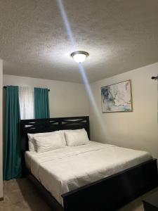 a bedroom with a bed with a light on the ceiling at quiet and comfortable in Cleveland