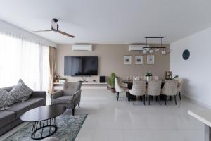 a living room with a couch and a table at Spacious 3BR Sea-View Condo Resort Amenities 2708 in Laguna Phuket