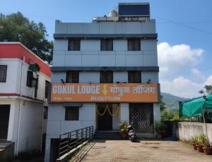 a building with a sign in front of it at Hotel O Gokul Lodging in Pune +6 photos