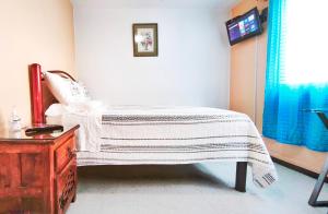 a bedroom with a bed and a dresser and a tv at Cozy bedroom at 5 min Mexico City Airport T1 & T2 in Mexico City