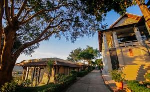 a house on a street next to a tree at Luang Prabang View Hotel in Luang Prabang