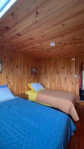 Ένα ή περισσότερα κρεβάτια σε δωμάτιο στο Panguipulli Cabañas Los Tallos