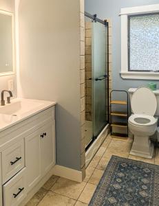 a bathroom with a shower and a toilet and a sink at Beautiful Bar Harbor House in Bar Harbor +26 photos