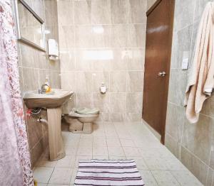 a bathroom with a sink and a toilet at Cozy bedroom at 5 min Mexico City Airport T1 & T2 in Mexico City
