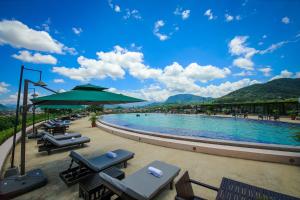 a swimming pool with lounge chairs and an umbrella at Luang Prabang View Hotel in Luang Prabang +27 photos