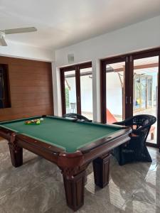 a billiard room with a pool table and chairs at Rusto Villa in Nathon Bay