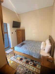Ένα ή περισσότερα κρεβάτια σε δωμάτιο στο Ajeng Homestay Uluwatu