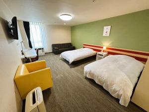 a hotel room with two beds and a couch at Hokkaido Greenland Hotel Sunplaza in Iwamizawa +80 photos