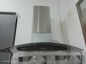 a close up of a stove with a glass top at Sri Midin Stay in Kuala Terengganu