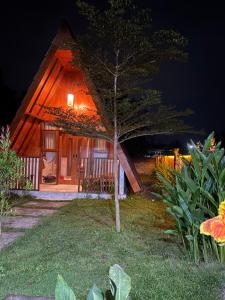 a house with a tree in front of it at night at Rinjani view bungalow in Masbagik
