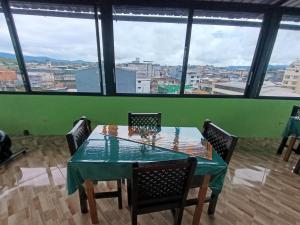 a table and chairs with a view of a city at Centro Macas in Macas