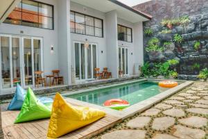 a swimming pool in the backyard of a house at Tropical Boho Loft Villa with Sofa Beds in Canggu