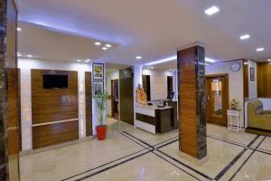 a large living room with a television and a couch at Hotel Mayur Katra in Jāmb