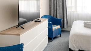 a bedroom with a dresser with a tv and a bed at Del Rae Unit 8 25 Shoal Bay Road in Shoal Bay