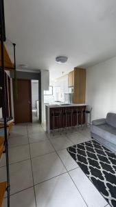 a living room with a couch and a kitchen at Standard Garden 02 in Caruaru