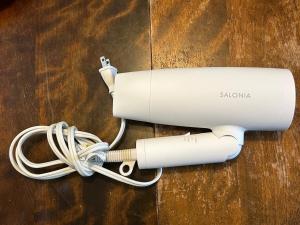 a white hair dryer with a cord on a table at Akane Craft Inn in Hachinohe