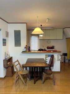 a kitchen and dining room with a table and chairs at Akane Craft Inn in Hachinohe +11 photos