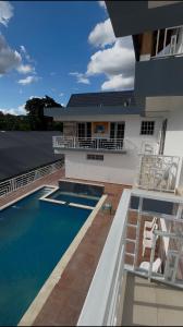 a house with a swimming pool in front of a house at Suite Terraza Verde Inoa in Inoa
