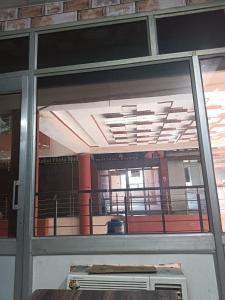 a glass door of a building with a balcony at Hotel razia in Manāli