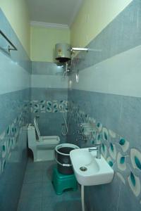 a bathroom with a sink and a toilet at Sri Dattatreya Nivas in Pithāpuram