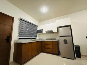 a kitchen with a stainless steel refrigerator and cabinets at Atlántico departamento in Mazatlán