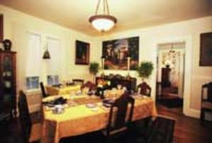 a living room with a table and a dining room at Red Elephant Inn Bed and Breakfast in North Conway