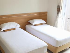 Ένα ή περισσότερα κρεβάτια σε δωμάτιο στο Wisma Pelangi 5 +9 φωτογραφίες