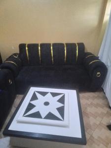 a black couch with a star on a table at Keroka Luxury Apartment in Keroka