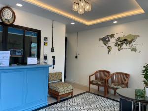 a waiting room with two chairs and a world map on the wall at Airport one station hometel - Suvarnabhumi - SHA Extra Plus in Bangkok
