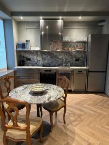 a kitchen with a table and chairs and a counter at Aparthotel in Chişinău