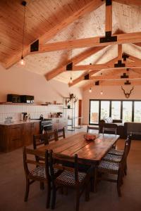 a dining room with a wooden table and chairs at Leeuwkuil Lodge in Philipstown
