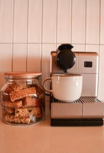 a counter with a mixer and a jar of food at Leeuwkuil Lodge in Philipstown