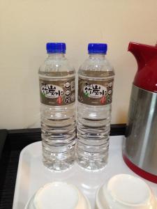 two bottles of water sit on a counter top at Big Bear Hotel in Kaohsiung