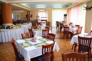 a dining room with white tables and chairs at Hotel Kristel Park - All Inclusive Light in Kranevo