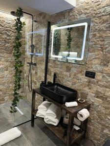 a bathroom with a black sink and a mirror at Elfriede Residence in Braşov +11 photos