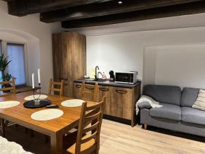 a living room with a table and a couch at Elfriede Residence in Braşov