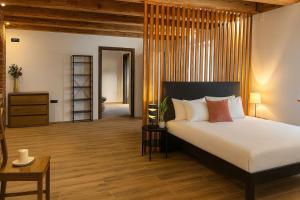 a bedroom with a large bed and a wooden floor at Elfriede Residence in Braşov