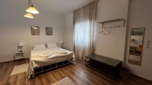 a bedroom with a bed with towels on it at Cloud9Rest & Fly in Koropíon