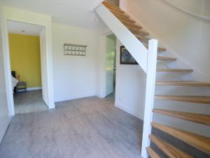 a hallway with stairs in a house at Villa in Texel near Beach and Nature Reserve in Westermient