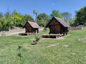 two small huts in a grassy field at Mini-Camp SKELICA in Neštin