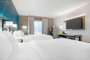 a hotel room with two beds and a flat screen tv at Comfort Inn Livingston in Livingston +33 photos