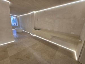 a white room with a bench on the wall at DUNE at Spanish Steps Luxury Apartment-Suite in Rome