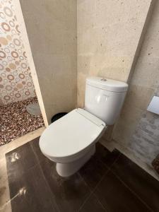 a bathroom with a white toilet in a room at AMED LILI Hostel & Private Room in Amed +18 photos