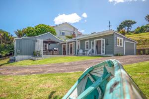a house with a boat in front of it at Quintessential Russell Cottage in Russell +10 photos