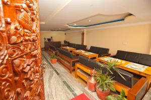 a restaurant with wooden tables and chairs in a room at The Boudha Inn in Kathmandu