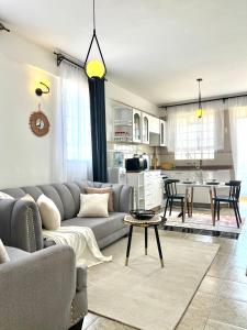 a living room with a couch and a table at Dovy 1br Milimani with AC in Kisumu