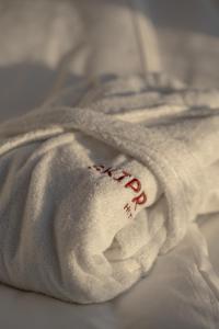 a white towel with the word hospital written on it at SKIPR Hotel - adults only in Antwerp +38 photos