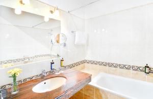 a bathroom with a sink and a mirror at Grand Hotel Praha in Tatranská Lomnica